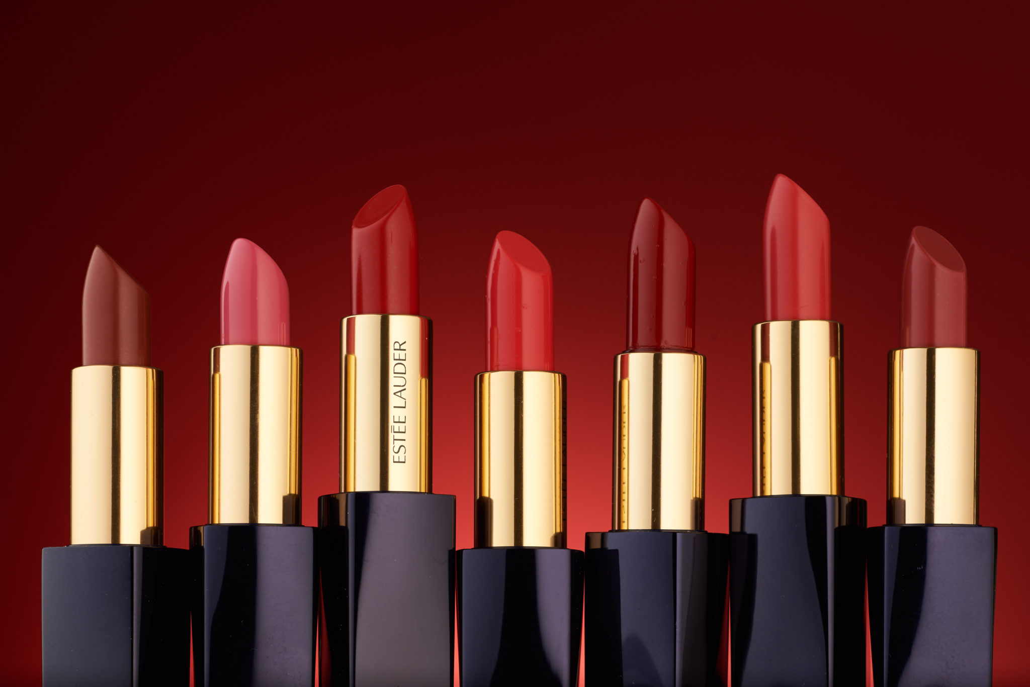 multiple Shades of different Estee Lauder lip stick products lined up
