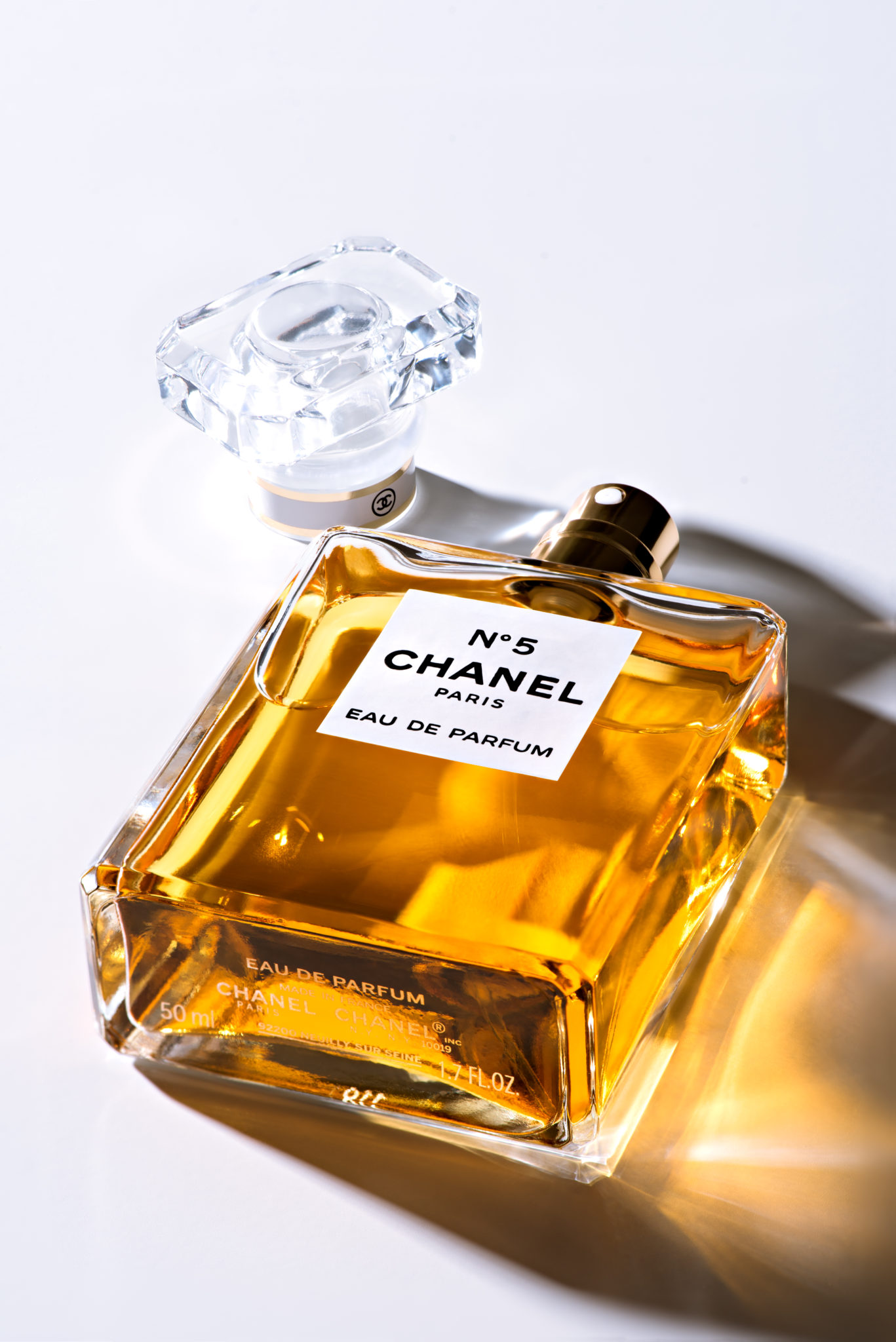 a Bottle of N°5 Chanel Perfume laying flat at an angle in studio for a commercial product shoot