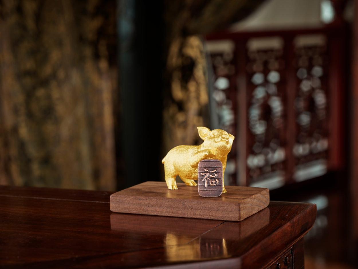 Shiny Golden Pig Statue on a counter