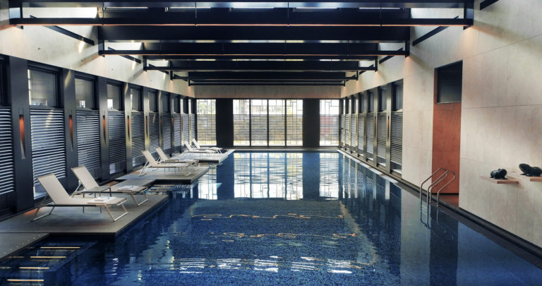 spacious interior of an indoor pool by WOHA